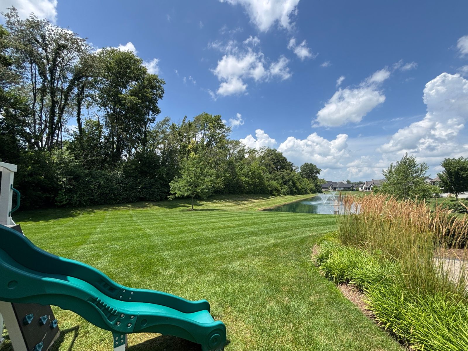 Striped lawn along neighborhood pond